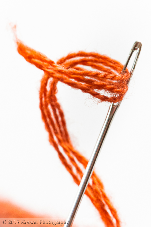 Needle and thread in orange